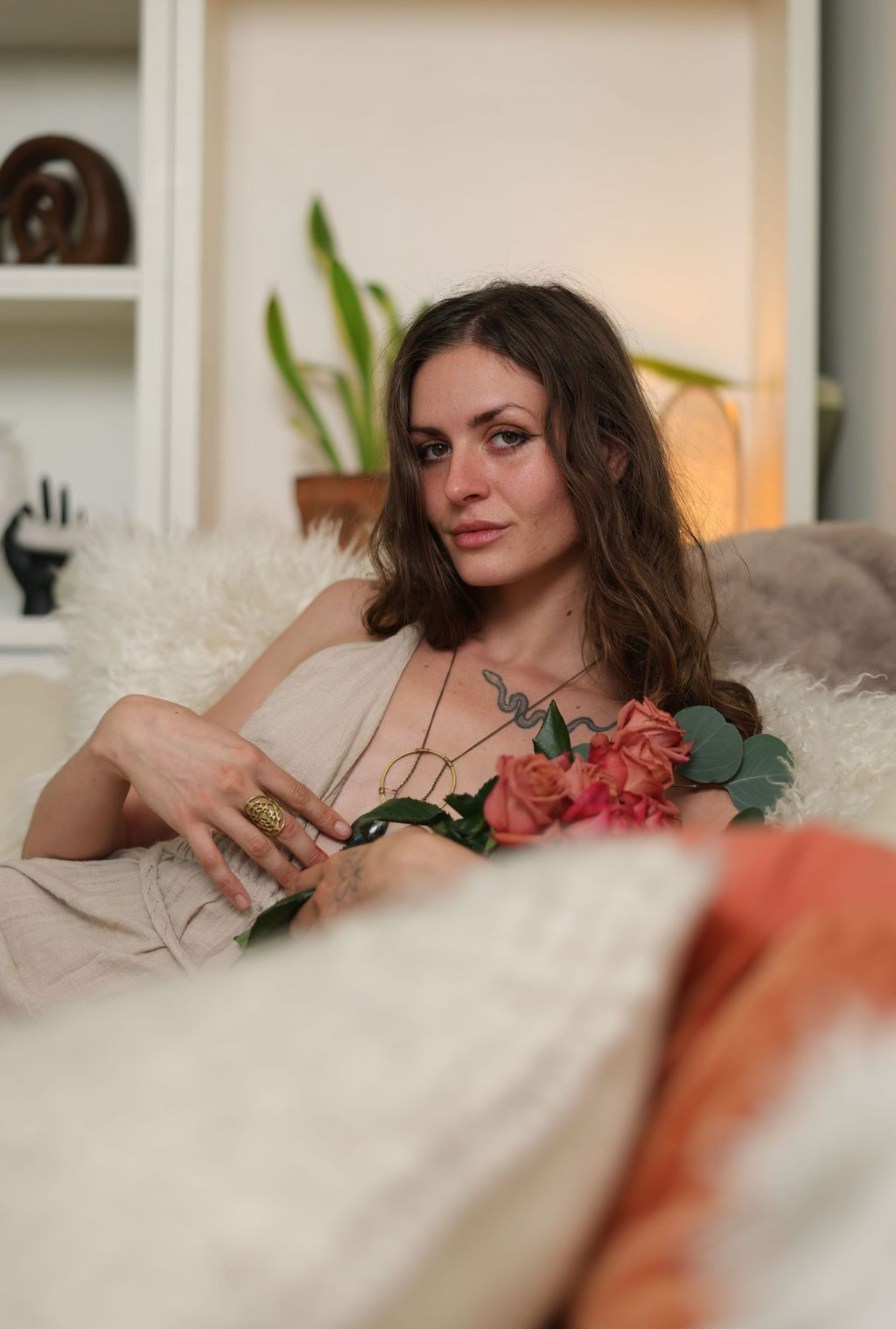 Portrait of your guide holding roses in a warm, sunlit room
